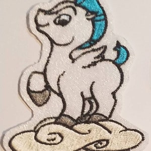 May include: White embroidered iron-on patch of Pegasus, a winged horse with a blue headband, standing on a white cloud with black outlines.