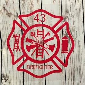 May include: Red firefighter emblem with a ladder, axe, hose, and fire hydrant. The number 43 is at the top and the word "FIREFIGHTER" is at the bottom.