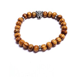 Natural round euro wood stretch bracelet with a tiger head spacer bead. (Silver or gold)
