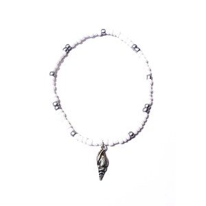May include: White beaded bracelet with silver beads and a silver seashell charm.