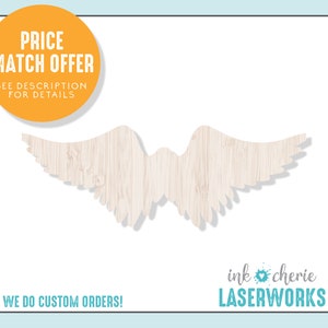 May include: A pair of wooden angel wings with a wood grain texture. The wings are white and have a shadow underneath. The text "ink cherie LASERWORKS" is at the bottom of the image.