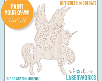 May include: A wooden cutout of a unicorn with wings, ready to be painted. The cutout is pre-scored for easy assembly. The image includes the text "PAINT YOUR OWN!" and "PRE-SCORED GUIDELINES".