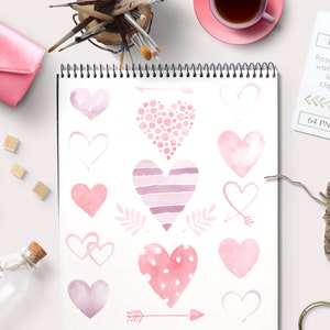 May include: A collection of 14 watercolor hearts in various shades of pink, with some hearts featuring polka dots, stripes, and outlines. The hearts are arranged on a white background with a few arrows and leaves.