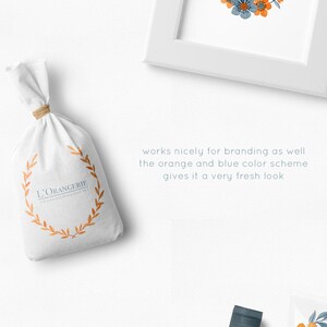 May include: A set of watercolor floral illustrations featuring orange and blue flowers, leaves, and branches. The illustrations are perfect for creating wreaths, patterns, and branding designs. The text "Love is Kind" is featured in a wreath.