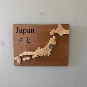 Japan or Okinawa. Base is cherry wood. Island is pine. Can be made with or without a clock. Can customize. Name is laser engraved.