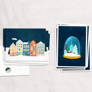 Set mit 10 illustrierten Weihnachtskarten mit Grachtenhäusern und Schneekugel, Illustration gemütlicher Winterhäuser, Glückwünsche für das neue Jahr