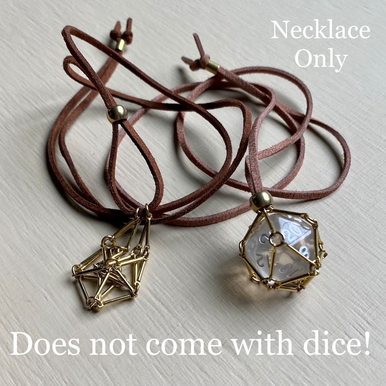 May include: Two brown leather cord necklaces with gold metal clasps. One necklace has a gold geometric pendant, the other has a gold cage with a clear glass twenty-sided die inside. "Necklace Only" and "Does not come with dice!" are written in black text on a white background.