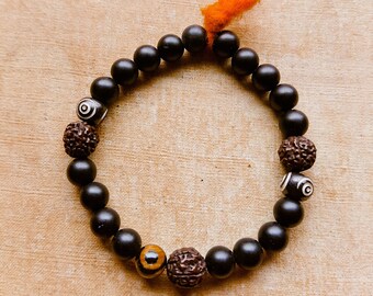 DURGA bracelet  / matte black and Rudraksha / Yak Bone Third Eye  / wool tassel / stretch bracelet