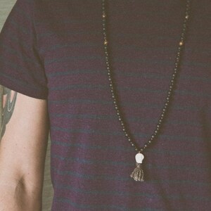 Black Kali Mala Necklace worn by a man • Lava & Bronzite 108 Beads Yak Wool Meditation beads • Carved Bone Skull Jewelry