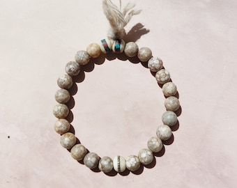 unisex SPIRIT OF the MOUNTAINS bracelet  / Fossil Coral from the Himalayas and Yak bone / Yak wool tassel / stretch bracelet