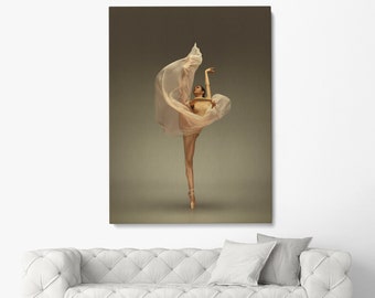 May include: A ballerina in a white tulle skirt dances on a brown background. The skirt is flowing around her as she poses with her leg extended.