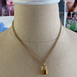 Gold chain necklace with lock pendant