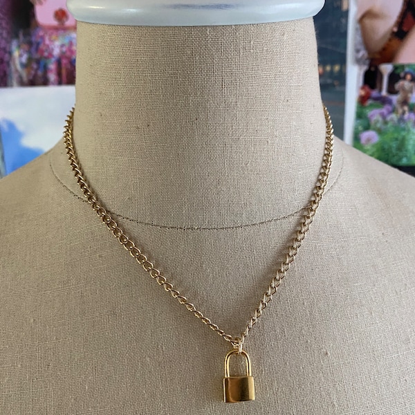 Gold chain necklace with lock pendant