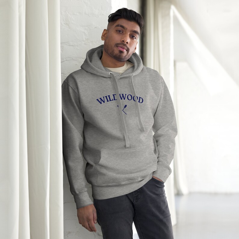 May include: A gray hooded sweatshirt with the text "WILE WOOD" and a pair of crossed oars in navy blue.