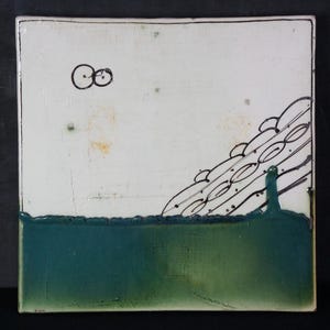 May include: Square ceramic tile with a white background and a teal green lower section. The tile features a minimalist design with black line art depicting a stylized landscape with two circles and a series of curved lines.
