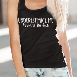 May include: Black tank top with white text that reads "UNDERESTIMATE ME that'll be fun".