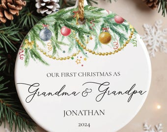 May include: A white Christmas ornament with a festive design. The ornament features text that reads "Our First Christmas As Grandma & Grandpa" with the name "Jonathan" and the year "2024". The ornament is decorated with Christmas tree branches, ornaments, and gold accents.