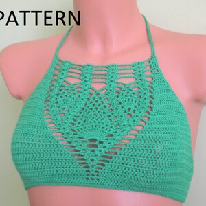 May include: A green crochet halter top with a decorative openwork design on the front. The word "PATTERN" is in the upper left corner. The top is displayed on a mannequin.