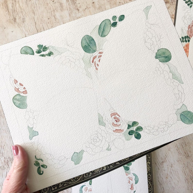 May include: A watercolour painting of a floral border with green leaves and pink flowers. The painting is on a white background and is unfinished.