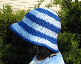 May include: A blue and white striped crocheted sun hat with a wide brim.