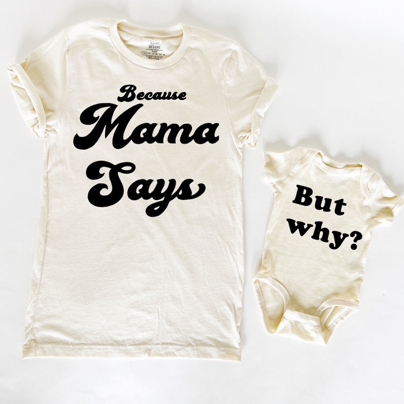 May include: A set of two cream-colored t-shirts with black text. The larger shirt says "Because Mama Says" in a retro font. The smaller shirt says "But why?" in a block font.