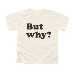 May include: A white t-shirt with the text "But why?" printed in black.