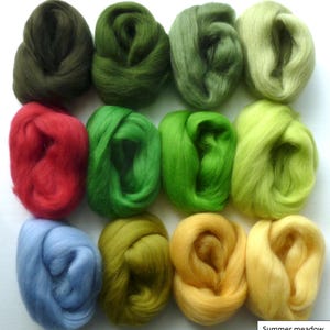 May include: Twelve balls of wool in various shades of green, yellow, red, and blue. The balls are arranged in a grid pattern on a white surface. The text "Summer meadow" is written below the balls.