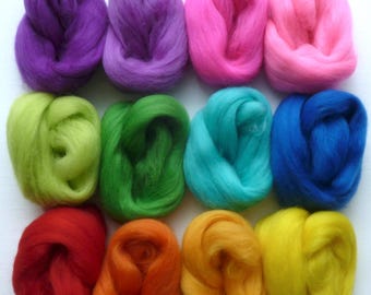 May include: Twelve balls of wool in various colors of the rainbow. The colors are purple, green, blue, red, orange, and yellow.
