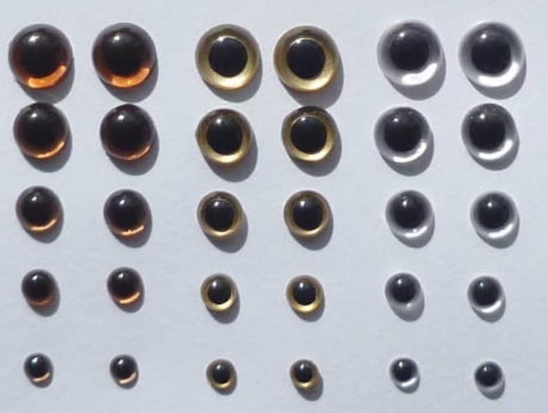Puede incluir: Surtido de ojos de pl&aacute;stico para manualidades en varios tama&ntilde;os. Los ojos son marrones, dorados y plateados.