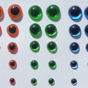 Puede incluir: Surtido de ojos saltones de pl&aacute;stico en varios tama&ntilde;os y colores, incluyendo naranja, verde y azul.