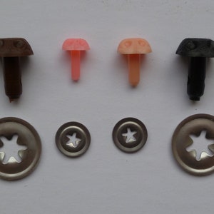 May include: Assortment of plastic safety eyes for crafts, with brown, pink, and black colors. The eyes come with metal washers for securing them to fabric or other materials.