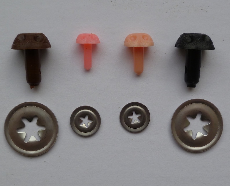 May include: Assortment of plastic safety eyes for crafts, with brown, pink, and black colors. The eyes come with metal washers for securing them to fabric or other materials.