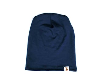 May include: A navy blue beanie with a small brown logo on the bottom right side.