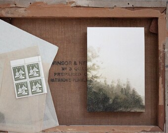 May include: A framed watercolour painting of a forest scene with a light grey background. The painting is in a wooden frame with a label that reads "Windsor & Newton No 3 Queen Anne's Gate,  Prepared Oil Colours,  Rathbone Place, London".
