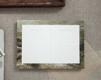May include: A blank notepad with a green and brown landscape design. The notepad is divided into two sections, one labelled "Things to Do" and the other labelled "Notes to Take".