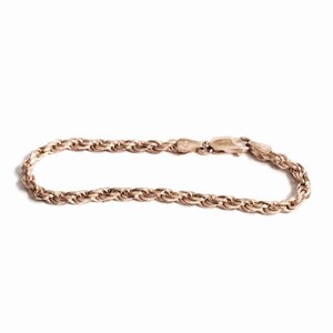 May include: A rose gold rope chain bracelet with a lobster clasp.