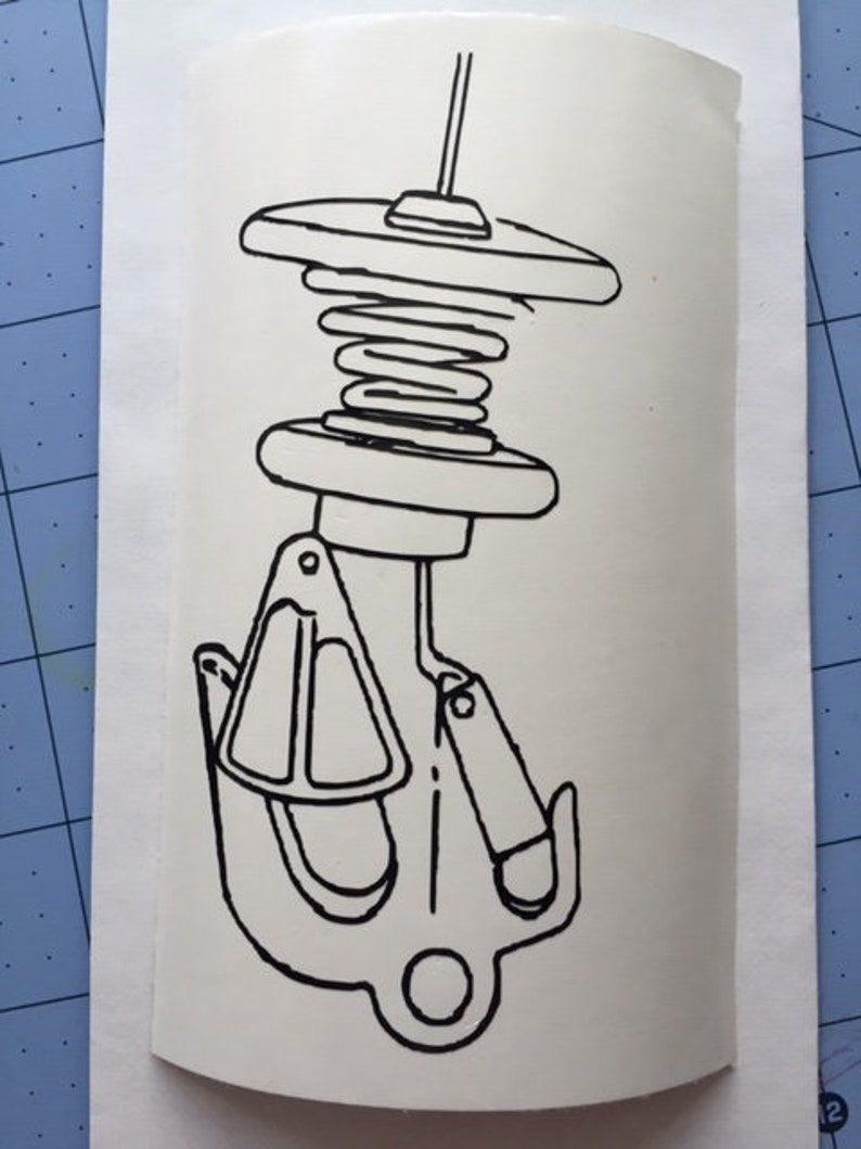 May include: A black and white line drawing of a boat cleat with a spring-loaded mechanism. The cleat is designed to secure a rope or line.