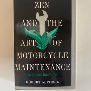 May include: A black book cover with the title "Zen and the Art of Motorcycle Maintenance: An Inquiry into Values" by Robert M. Pirsig. The cover features a wrench and green leaves.