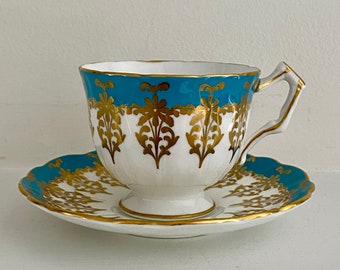 Oszałamiająca, zabytkowa filiżanka z porcelany kostnej Aynsley, w kształcie gorsetu, w kolorze turkusowym i złotym, z motywem kwiatowym, brytyjska porcelana, filiżanka ze spodkiem, do herbaty, połowa XX wieku