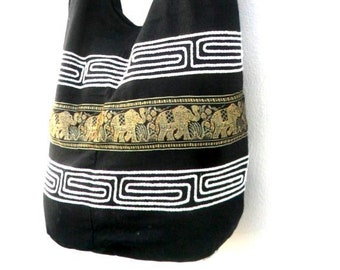 May include: Black cotton tote bag with a white geometric pattern and a gold and black elephant design.