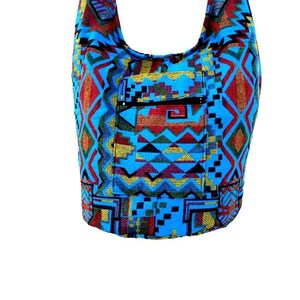 May include: A blue, red, yellow, and green patterned shoulder bag with a zippered pocket.