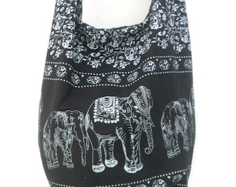 May include: Black cotton shoulder bag with a white floral pattern and three white elephants printed on the front.