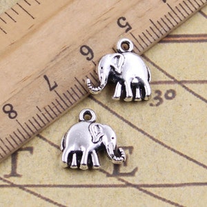 May include: Two silver elephant charms with a loop at the top for attaching to jewelry or other crafts.