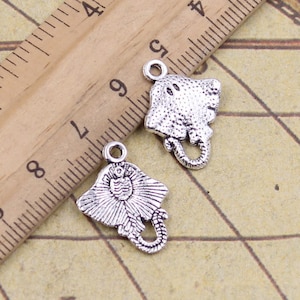 Puede incluir: Dos abalorios de metal plateados con forma de raya. Los abalorios tienen un diseño detallado y son perfectos para la elaboración de joyas.