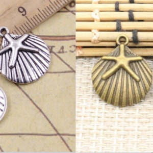 May include: Two silver and two bronze charms in the shape of a seashell with a starfish inside. The charms have a loop at the top for attaching to a necklace or bracelet.