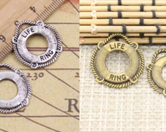 May include: Two silver and two gold-toned life ring charms with the words "Life Ring" engraved on them. The charms are about 1 inch in diameter.