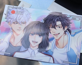 May include: A printed photograph featuring three anime characters. The characters are a young woman with dark hair wearing a white shirt, a young man with white hair wearing a white shirt, and a young man with dark hair wearing a blue and white shirt. The photo is framed with a white border and has a red "REC" button in the top left corner.