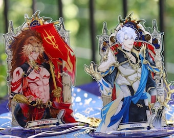 May include: Three acrylic character stands featuring anime-style illustrations. The characters are depicted in ornate outfits with detailed designs. The stands are on a blue surface with gold accents. The characters' names are printed on the base of each stand.