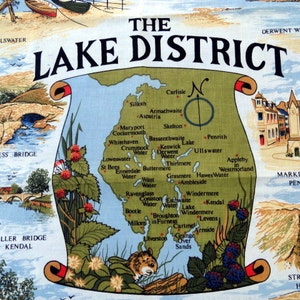 May include: A colorful map of the Lake District in England, with a compass rose and the words "The Lake District" in a banner at the top. The map shows the locations of various towns, lakes, and mountains in the region. The map is surrounded by a border of green leaves and berries.