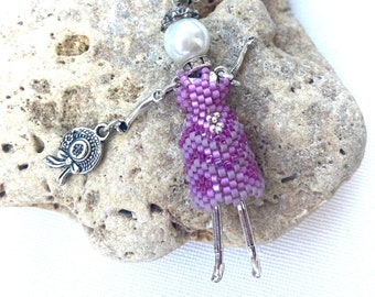 Purple beaded French doll necklace with a hat